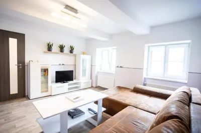 a living room with a couch and a table at Spacious Apartment 20 Min from National Theatre in Prague