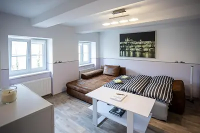 a living room with a couch and a table at Spacious Apartment 20 Min from National Theatre in Prague