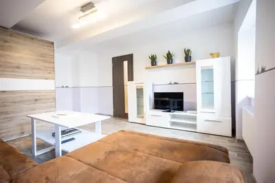 a living room with a couch and a table at Spacious Apartment 20 Min from National Theatre in Prague