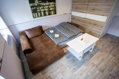 a small living room with a couch and a table at Spacious Apartment 20 Min from National Theatre in Prague