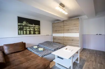 a living room with a couch and a table at Spacious Apartment 20 Min from National Theatre in Prague