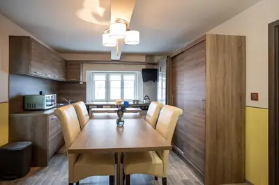 a dining room with a wooden table and chairs at Spacious Apartment 20 Min from National Theatre in Prague