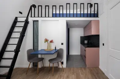 a room with a blue table and chairs and a bunk bed at Stay2gether M&M Studio Holešovice in Prague