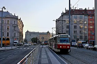 a train traveling down the tracks in a city at Stay2gether M&M Studio Holešovice in Prague