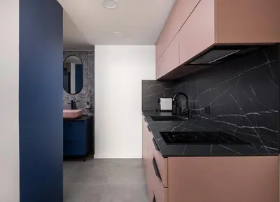 a kitchen with black marble counter tops and a sink at Stay2gether M&M Studio Holešovice in Prague