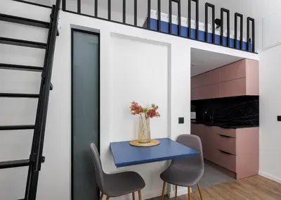 a room with a blue table and chairs and a loft bed at Stay2gether M&M Studio Holešovice in Prague
