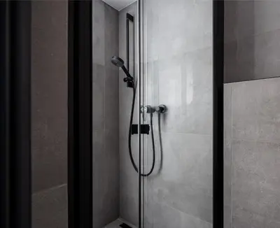 a shower with a shower head in a bathroom at Stay2gether M&M Studio Holešovice in Prague