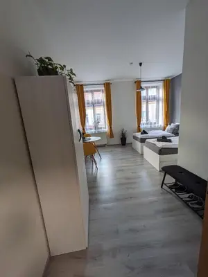 a living room with a door open to a bedroom at Penzion Grand Nymburk in Nymburk