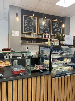 a bakery with a counter with different types of pastries at Penzion Grand Nymburk in Nymburk