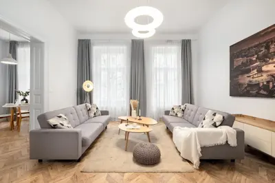a living room with two couches and a table at Prague Days - Spacious Apartment with Balcony near Wenceslas Square in Prague