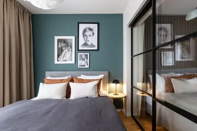 a bedroom with blue walls and a bed with white pillows at Prague Days - Deluxe Two-bedroom Apartment in New Town in Prague