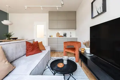 a living room with a couch and a table at Prague Days - Deluxe Two-bedroom Apartment in New Town in Prague