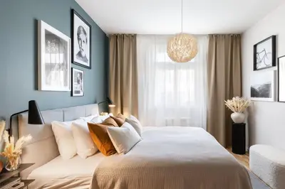 a bedroom with a large bed and a window at Prague Days - Deluxe Two-bedroom Apartment in New Town in Prague