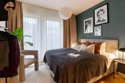 a bedroom with a bed and a chair in it at Prague Days - Deluxe Two-bedroom Apartment in New Town in Prague