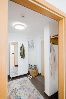 a room with a hallway with a mirror and a rug at Prague Days - Studio with Workspace by TV Tower in Žižkov in Prague