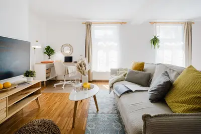 a living room with a couch and a table at Prague Days - Studio with Workspace by TV Tower in Žižkov in Prague
