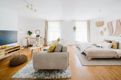 a living room with a couch and a tv at Prague Days - Studio with Workspace by TV Tower in Žižkov in Prague