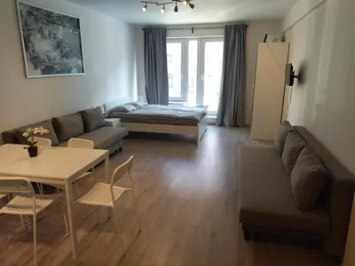 a living room with a couch and a table at Brand new studio apartment #24 in Elite residence with free secure parking in the center in Prague