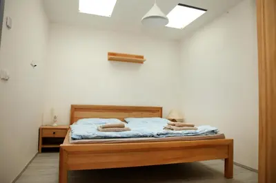 a bedroom with a bed with two pillows on it at Apartmán Ve Mlýně in Třebotov