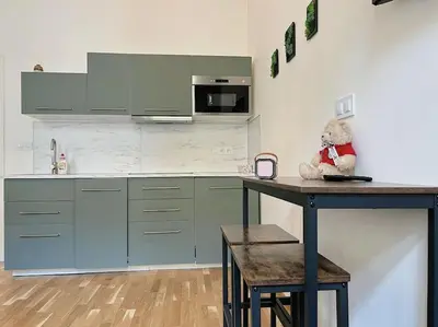 a teddy bear sitting on a counter in a kitchen at Apt near Muzeum Prague 1 in Prague