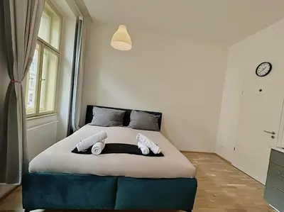a bedroom with a bed with two pillows on it at Apt near Muzeum Prague 1 in Prague