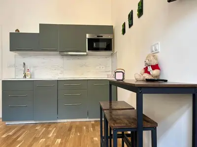 a teddy bear sitting on a counter in a kitchen at Apt near Muzeum Prague 1 in Prague