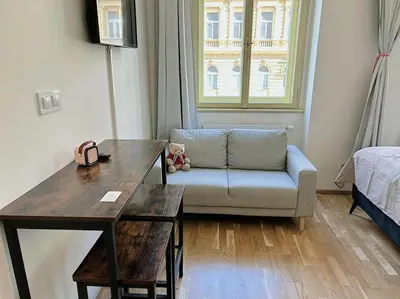 a living room with a couch and a table at Apt near Muzeum Prague 1 in Prague