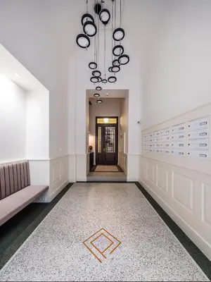 a hallway with a couch and a chandelier at Palace Dlazdena – Stylish Prague Centre Apartment in Prague