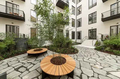 a patio with two tables and a building at Palace Dlazdena – Stylish Prague Centre Apartment in Prague