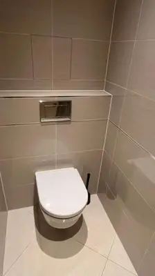 a bathroom with a white toilet in a stall at Residence Garden Tower - Parking in Prague