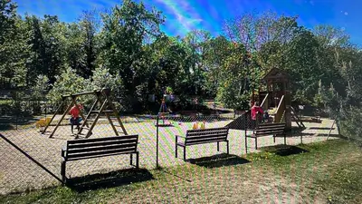 a playground with three benches and a swing set at Residence Garden Tower - Parking in Prague