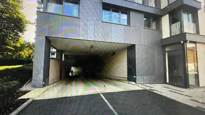 a building with a parking lot in front of it at Residence Garden Tower - Parking in Prague