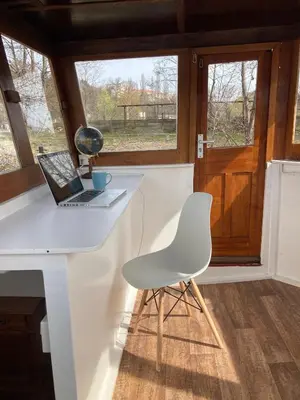 a white desk with a laptop and a chair at Prague on Boat, Privat Pier, Free Parking in Prague