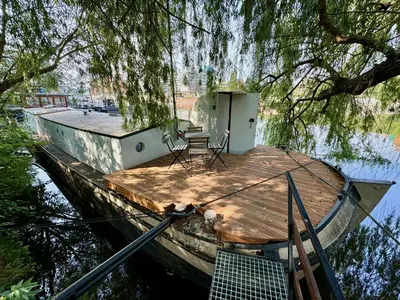 a small dock with a table and chairs on it at Prague on Boat, Privat Pier, Free Parking in Prague