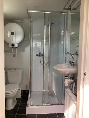 a bathroom with a shower and a toilet and a sink at Prague on Boat, Privat Pier, Free Parking in Prague