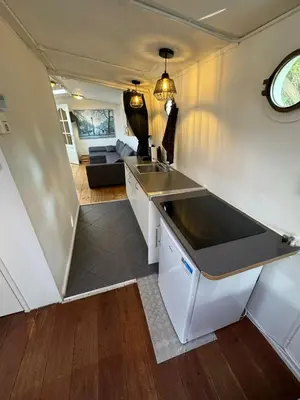 a kitchen with a sink and a living room at Prague on Boat, Privat Pier, Free Parking in Prague
