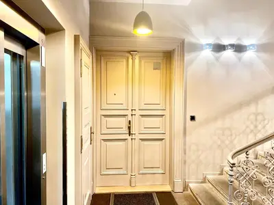 a hallway with a white door with a bow tie at exclusive apartment centrum Prague in Prague