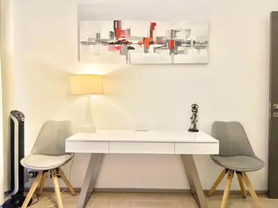 a white desk with two chairs and a lamp at exclusive apartment centrum Prague in Prague