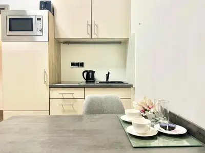 a kitchen with a table with cups and saucers on it at exclusive apartment centrum Prague in Prague