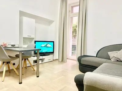 a living room with a couch and a table and a tv at exclusive apartment centrum Prague in Prague