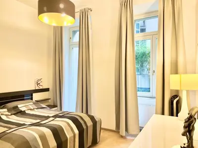 a bedroom with a bed and a window at exclusive apartment centrum Prague in Prague