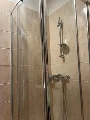 a shower in a bathroom with a glass door at Ubytování 1kk ve Zlonicích in Slaný