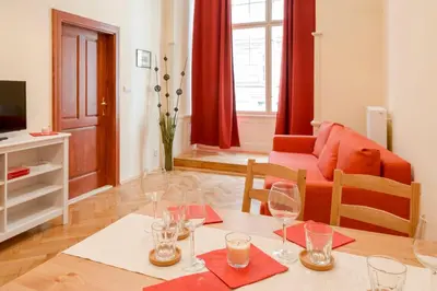 a living room with a table with wine glasses on it at Stella apartments in Prague