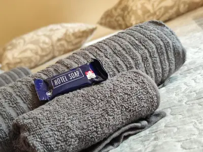 a pile of gray towels sitting on top of a bed at Stella apartments in Prague