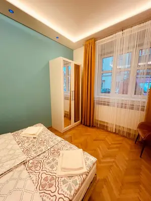 a bedroom with a bed and a large window at Modern apartment Na Hluboké in Prague in Prague
