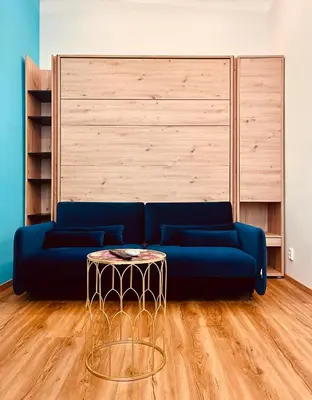 a living room with a blue couch and a table at Modern apartment Na Hluboké in Prague in Prague