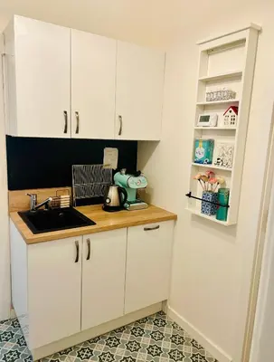 a kitchen with white cabinets and a sink at Modern apartment Na Hluboké in Prague in Prague