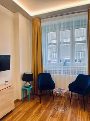 a living room with two chairs and a window at Modern apartment Na Hluboké in Prague in Prague