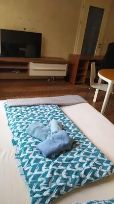 a room with a bed with a blue towel on it at Spacious Rooms in Prague 6 near center in Prague