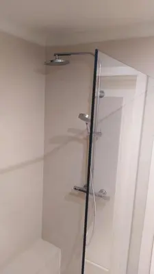 a glass shower stall in a white bathroom at Spacious Rooms in Prague 6 near center in Prague